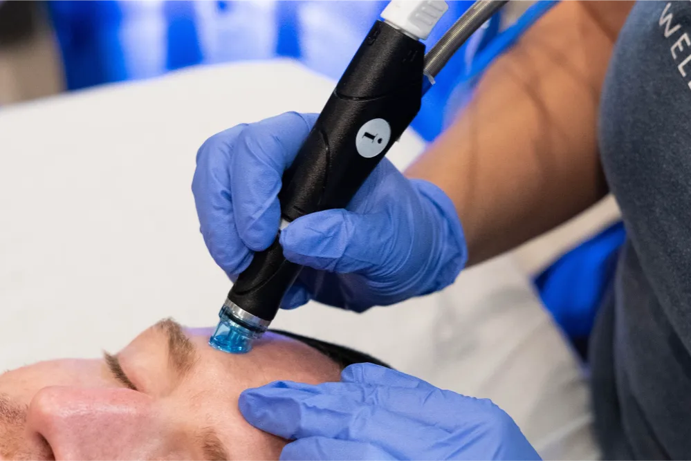 A man getting a hydra facial treatment.