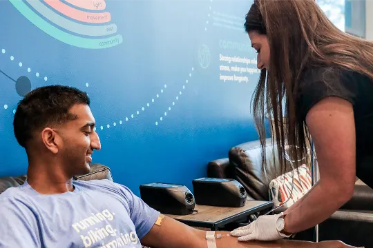 Man with dark hair getting an IV drip.