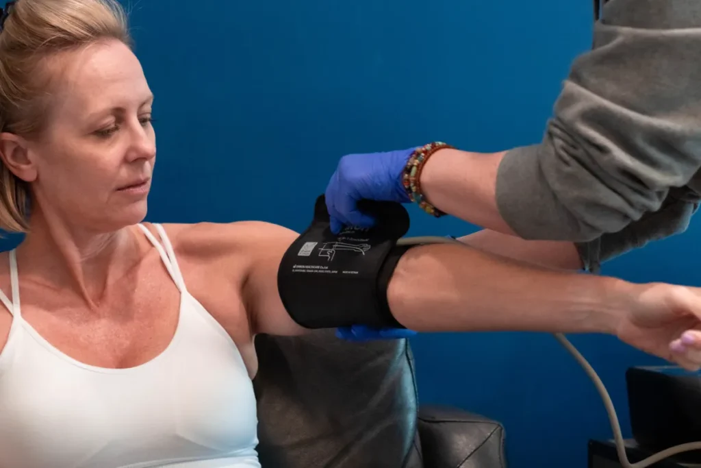 Blonde woman getting her blood pressure tested.