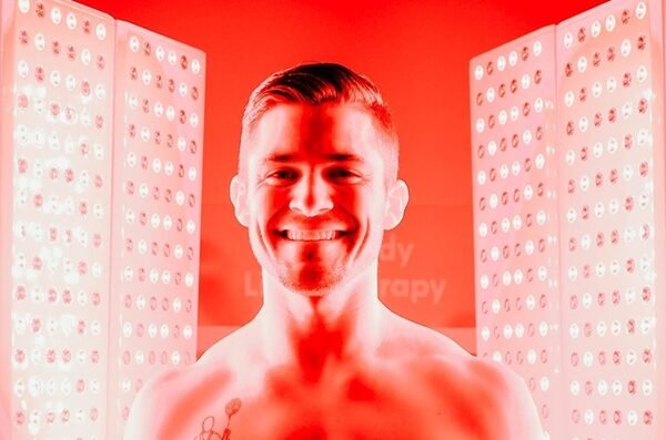 A man smiling during a red light therapy.