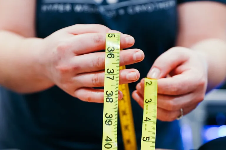 A person holding measuring tape.