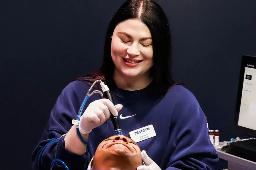 Two women smiling during a hydrafacial.