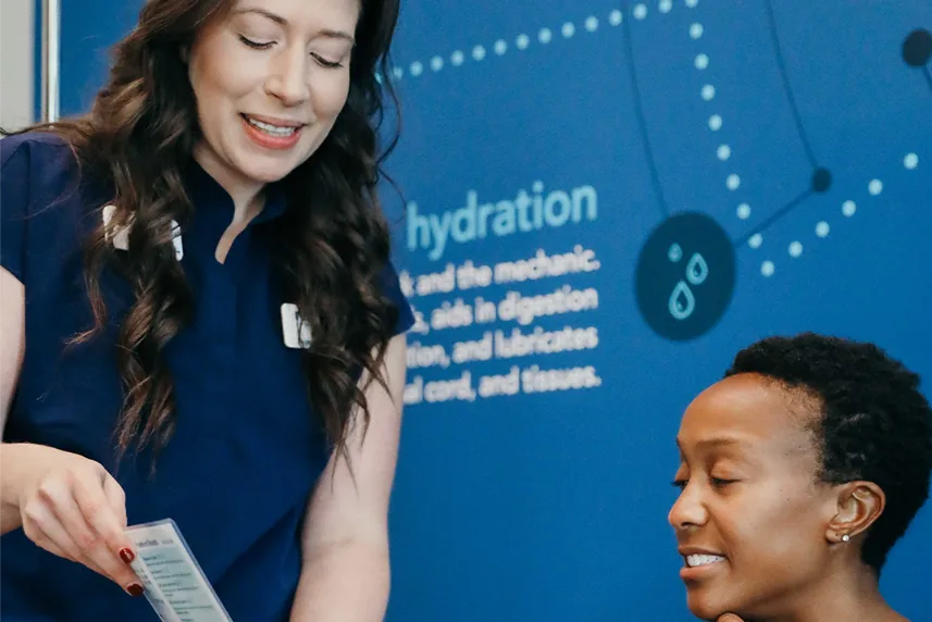 An employee showing a customer a pamphlet.